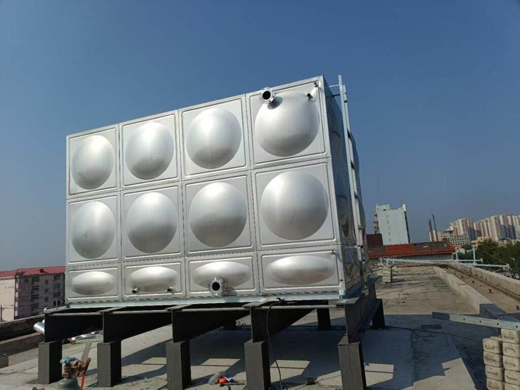 Bolted stainless steel water tank with domed pressed panels on a steel beam base