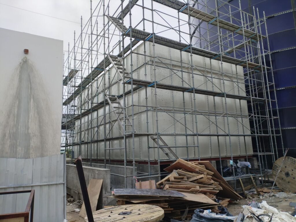 LVJIA GRP/FRP/SMC sectional water tank — panels being lifted into place on site