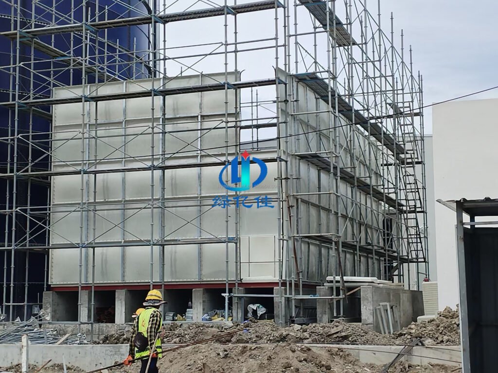 Sectional water tank installation in progress: a GRP sectional tank being assembled inside scaffolding