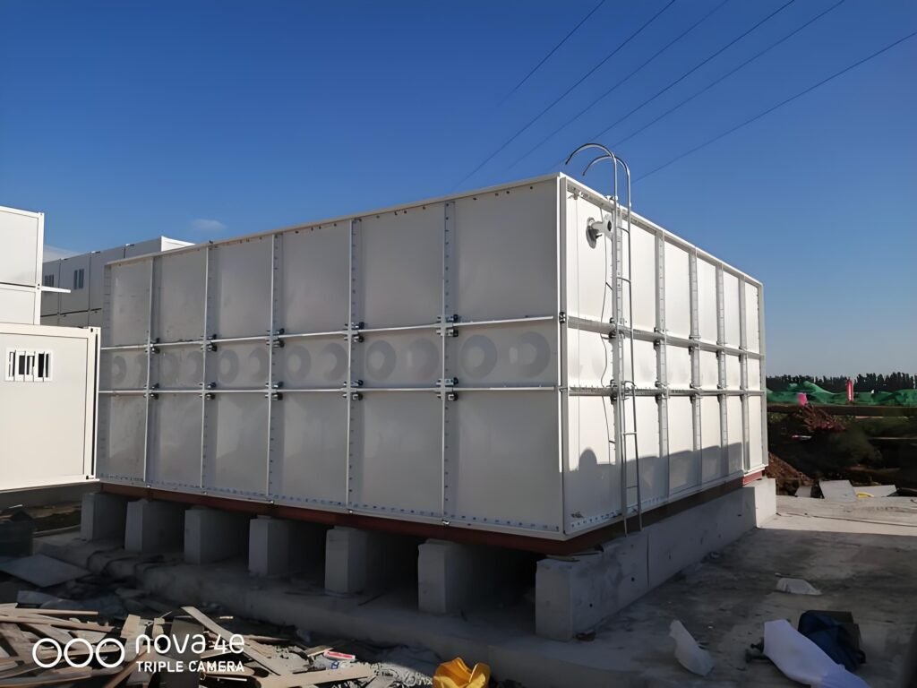 Sectional water tank foundation of parallel concrete strip plinths under a GRP tank