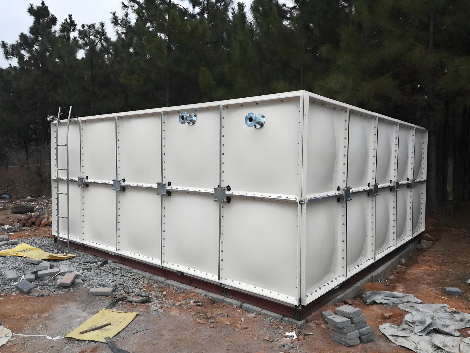 GRP sectional water tank on concrete plinths after assembly