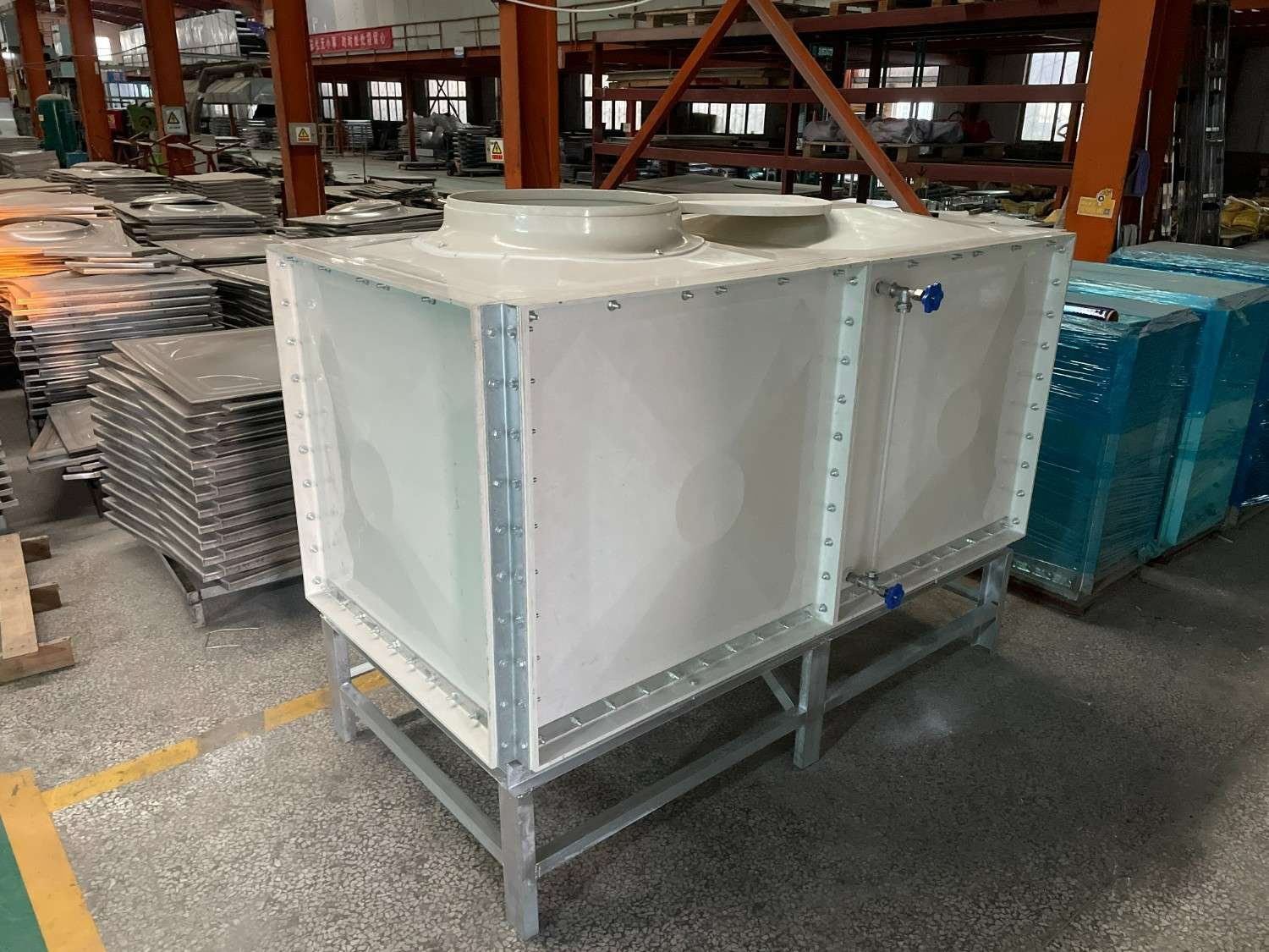 Custom built GRP water tank on a steel stand inside the LVJIA factory