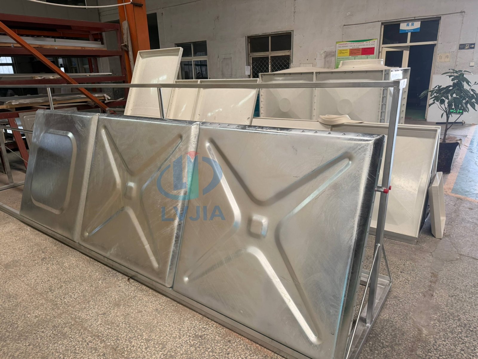 Hot-dip galvanized water tank panels stacked in the LVJIA workshop