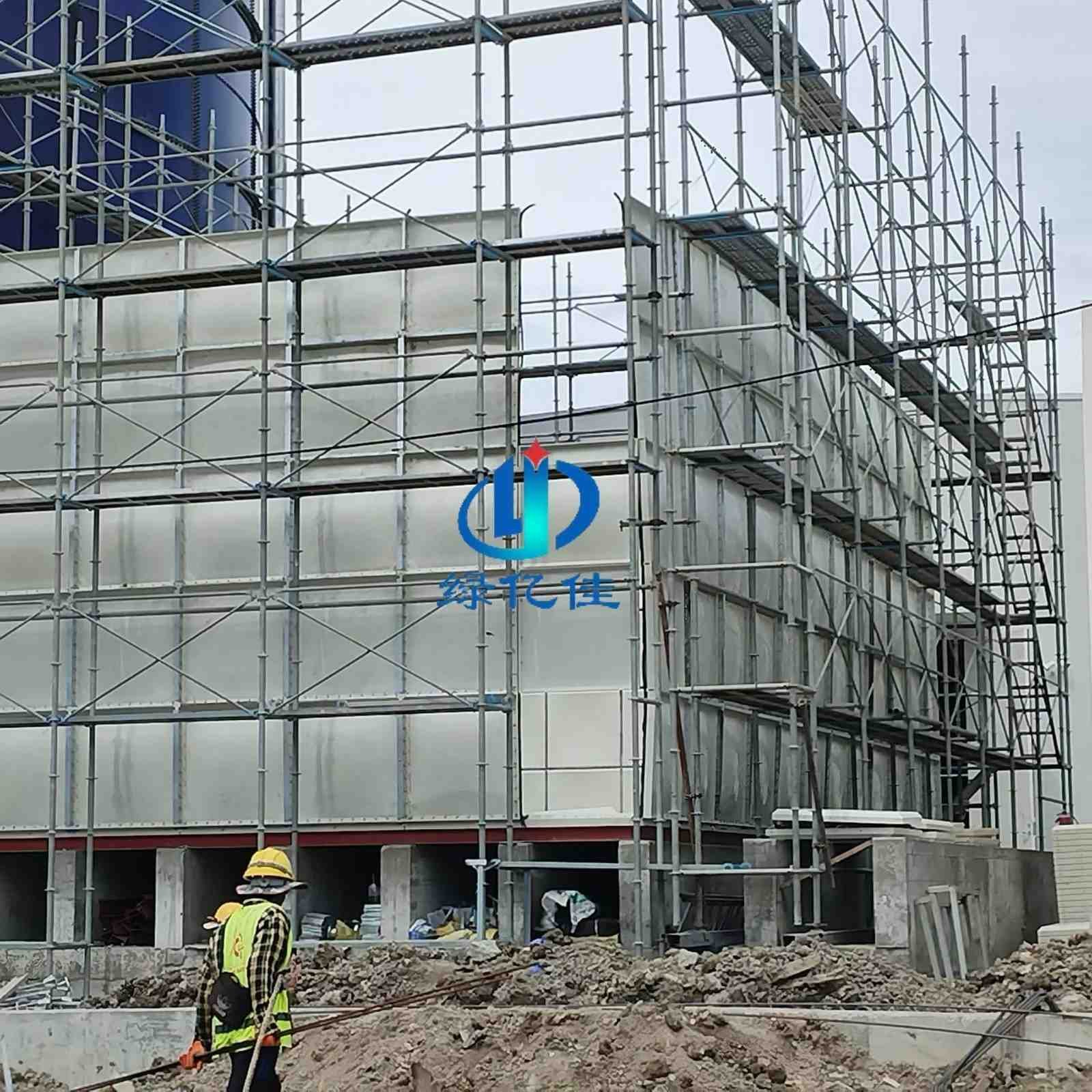 Large GRP / FRP sectional water tank being assembled panel by panel on site