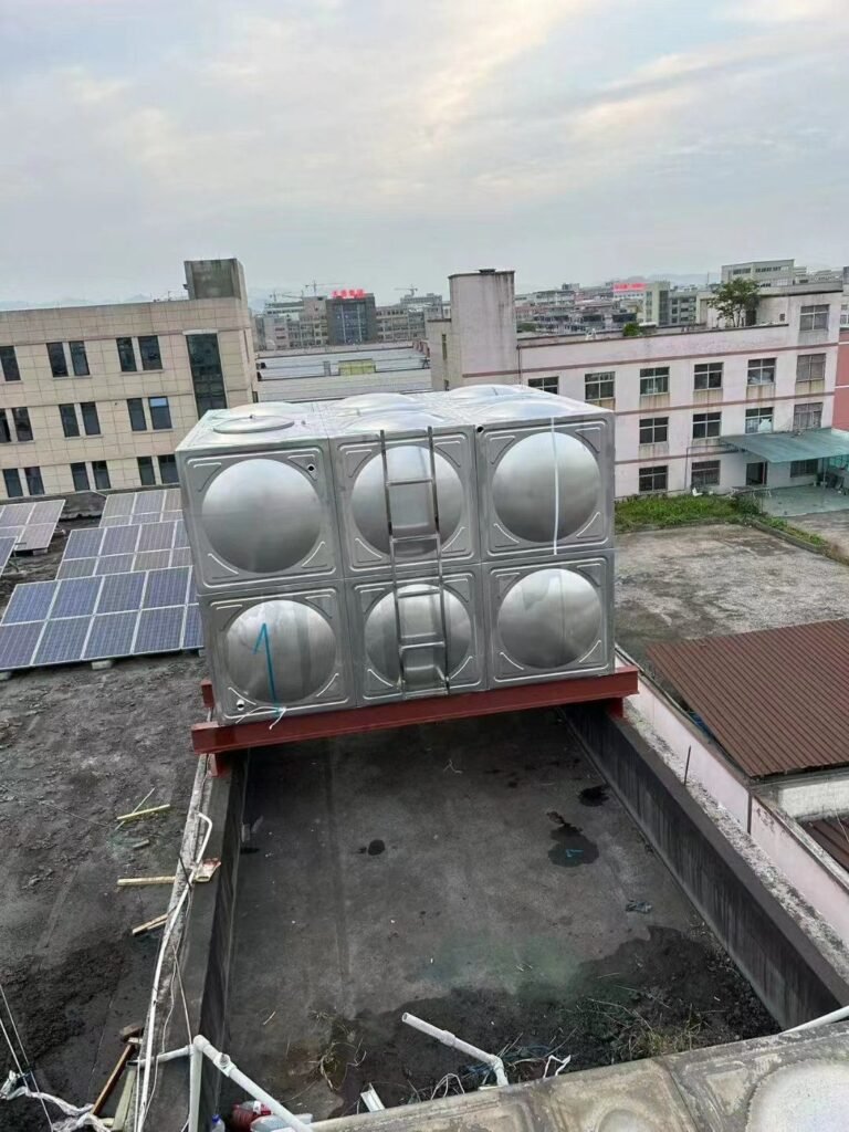 Stainless steel sectional water tank installed on a building roof